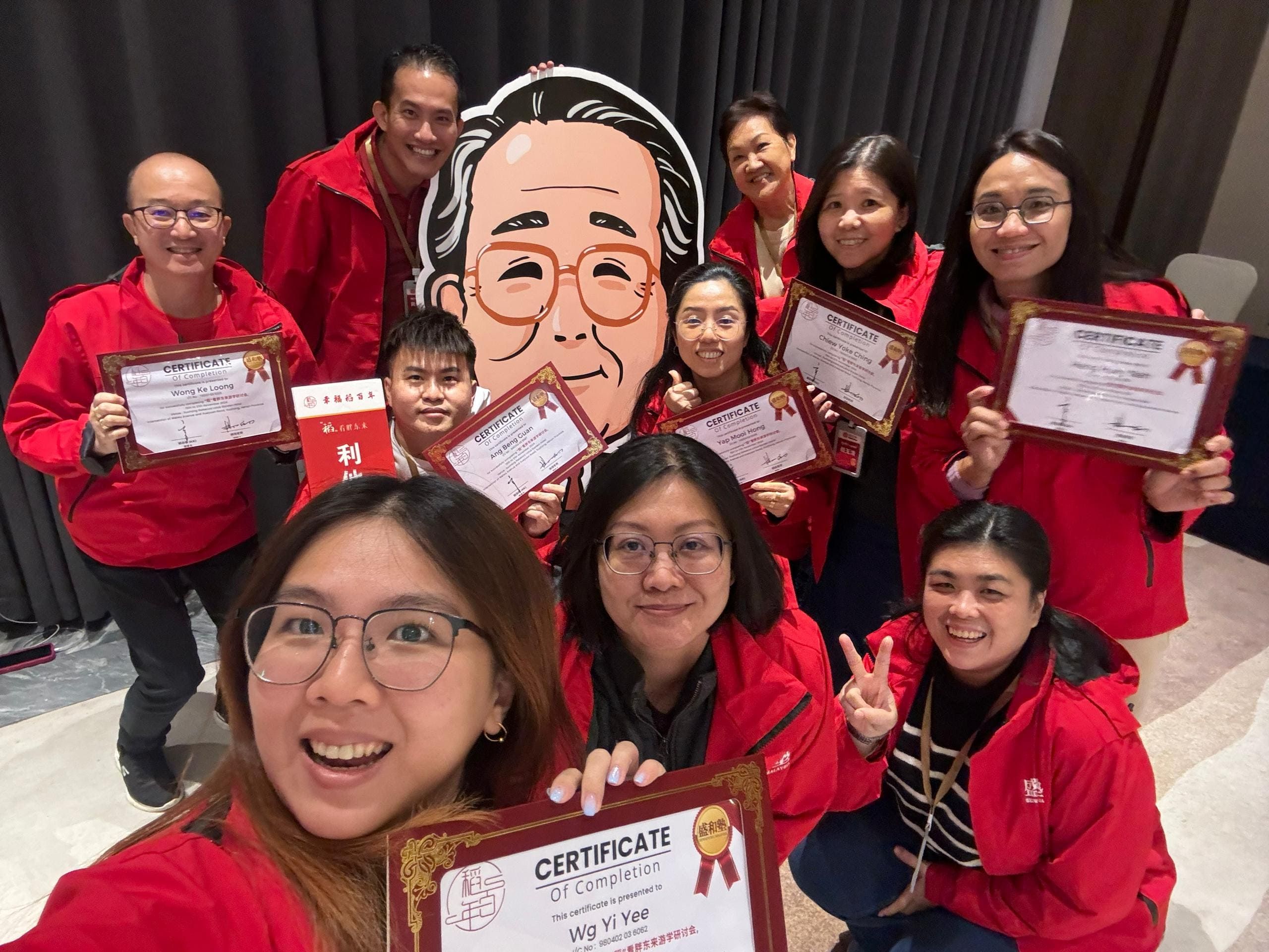 Group photo of staff members and agent receiving certification awards
