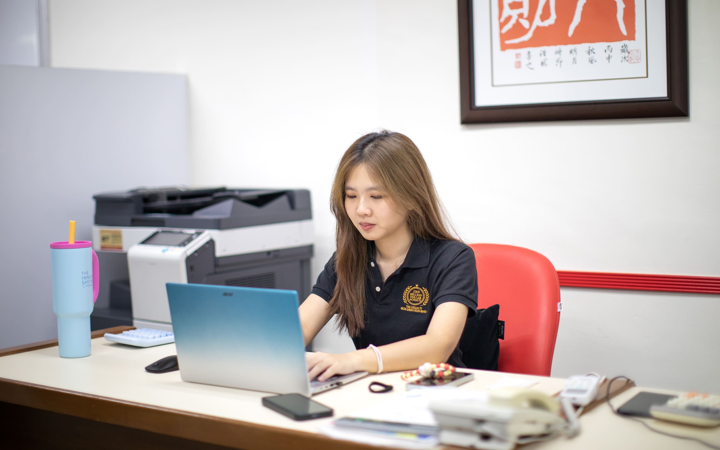 Staff member Fish working on a laptop